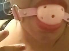 Kinky MILF shows off her gag ball and she drools
